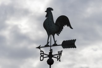 Weathercock silhouette against cloudy sky, looks mystical and dark, Baden-Württemberg, Germany