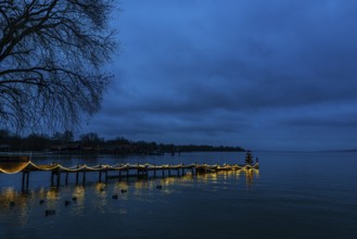 Illuminated Christmas tree at dawn, on an illuminated boat dock, Dießen am Lake Ammer, Upper
