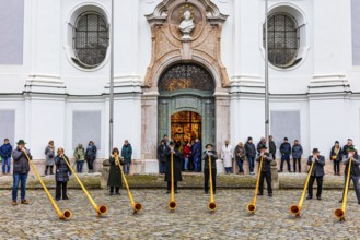 Alphorn group playing in front of Marienmünster in Dießen am Lake Ammer, Upper Bavaria, Bavaria,