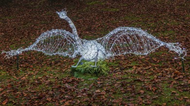 Swan made of wire and fairy lights, on leafy meadow, Historisches Hotel La Villa, Niederpöcking,