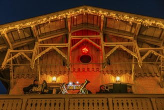 Brass band playing Christmas music on a balcony, Christkindlmarkt, Historisches Hotel La Villa,