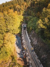Autumn view of construction site from the air with tunnel boring machine and construction vehicles