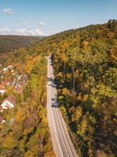 Railway tracks through autumn landscape with hills and a village, Bau der Hermann, Hesse, Bahn,
