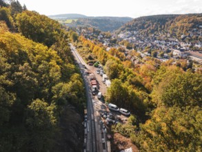 Construction site on railroad tracks in an autumn landscape next to a village, construction of