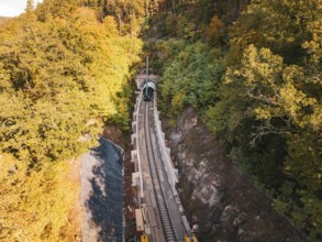 Aerial view of an autumn rail construction site in the forest, Hermann building, Hesse, railway,