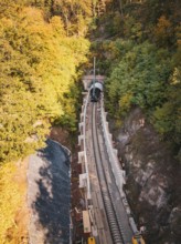 Autumn forest construction site taken from the air with a tunnel boring machine, construction of