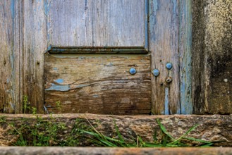 Details of an old baroque church door made of wood, weathered by time, in Ouro Preto city, Ouro