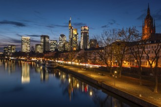 The Frankfurt banking skyline is reflected in the evening in the Main, Frankfurt am Main, Hesse,