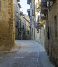 Narrow road alleyway street in medieval village of Uncastillo, Cinco Villas, Zaragoza province,