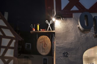 Nocturnal view of a tailor shop's nose shield, Lauf an der Pegnitz, Middle Franconia, Bavaria,