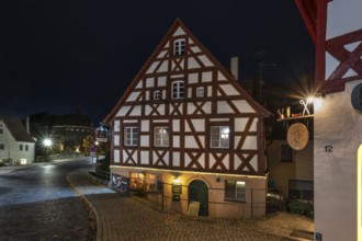 Night view of the historic half-timbered house, on the right the nose sign of a tailor shop, Lauf
