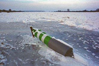 Buoy lying on ice rink, frozen Elbe, Bleckede, Lower Saxony, Germany, January 03, 1997, vintage,