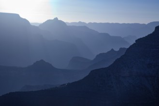 Scenic layers of the grand canyon in the early morning with hikers cabin roof shining in the lower