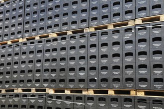 Stacked black beer crates from the Kulmbacher Group, a beverage manufacturer that includes