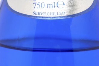 Glass with mineral water, small carbonated pearls on the edge of the glass, drinking water