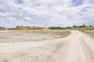 Landscape view with a gravel road in a limestone quarry on a sunny summer day