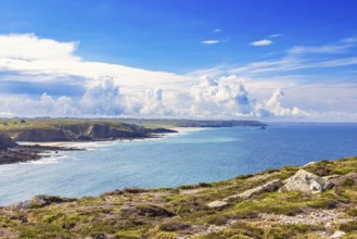 Seascape view at a seabay on a rocky coastline a sunny summer day by the sea with dramatic clouds