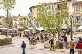 Town square in Sóller with outdoor restaurants and tourists a famous idyllic small town for