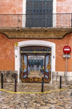 Restaurant with roll-down shutter blinds with graffiti painting on a street corner in the city,