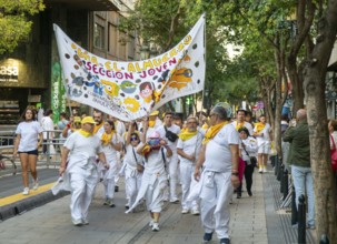 Evening procession through city streets by youth group organisation, Pilar 2025 festival event,