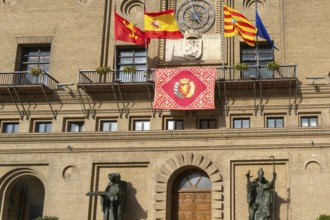 Flags flying Ayuntamiento city hall building, Plaza del Pilar, city centre of Zaragoza, Aragon,