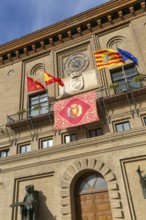 Flags flying Ayuntamiento city hall building, Plaza del Pilar, city centre of Zaragoza, Aragon,