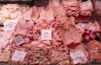 Market stall shop store selling butcher meat pork offal products inside Mercado Central de