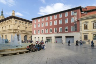 People sitting by fountain and historic buildings, Plaza la Seo, Zaragoza, Aragon, Spain