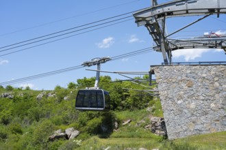 Close-up of a cable car gondola surrounded by nature and under clear skies, Tatev cable car, Wings