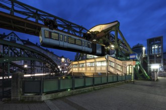 The Wuppertal suspension railway goes to the Werther Brücke stop, Wuppertal, Germany at blue hour,