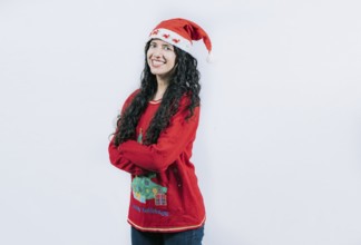 Smiling girl in Christmas hat with crossed arms. Portrait of smiling Latin girl in Christmas