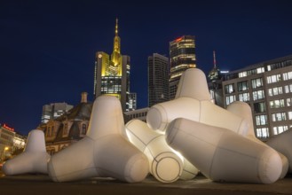 Illuminated tetrapods lie at Hauptwache in front of Frankfurt's banking skyline, Frankfurt, Hesse,