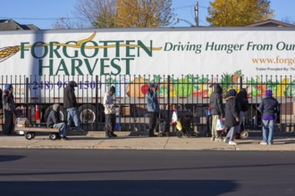Detroit, Michigan USA - 4 November 2025 - People wait in line to pick up groceries from the