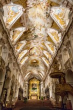 Main altar, pulpit and ceiling frescoes illuminated during Advent, central nave, rococo interior by