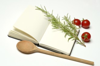 Blank notebook for cooking recipes, cooking spoon with rosemary sprig, tomato