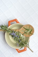 Rosemary, rosemary leaves on cooking spoon with cooking pot, rosemary sprig
