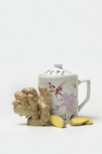 Ginger root with cup, ginger tea