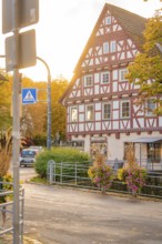 Half-timbered house in autumn surroundings with street lighting and flowers, Aidlingen, Böblingen