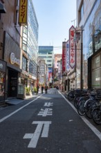 Street scene, lots of colorful signs of shops, restaurants and bars in a street, Shinjuku City,