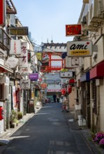 Lots of colorful signs of shops, restaurants and bars in a small alley, Shinjuku City, Tokyo, Japan