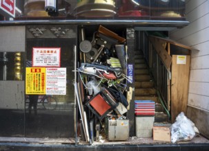 Bulky waste in a damaged house entrance, Shinjuku City, Tokyo, Japan