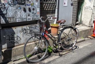 Locked bicycle on the side of the road, Shinjuku City, Tokyo, Japan
