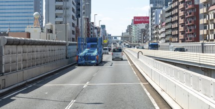 Multi-lane high street next to residential buildings, Shinjuku City, Tokyo, Japan