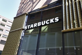 Glass façade with Starbucks lettering, Westfield Überseequartier, modern shopping center,