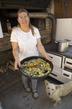 Serbian woman showing przeno or traditional Serbian dish in her kitchen, Vrmdza, Sokobanja, Serbia