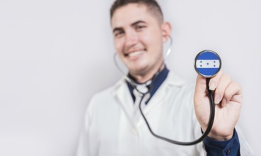Doctor showing stethoscope with Honduras flag. Honduras national healthcare concept