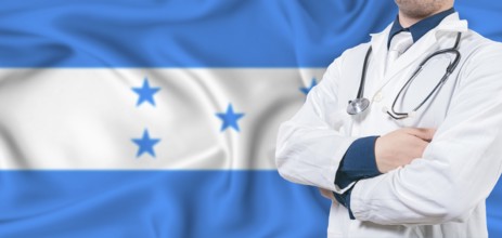 Honduras healthcare concept. Male doctor on Honduras flag. Doctor with crossed arms on Honduras