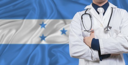 Male doctor with stethoscope on Honduras flag. Doctor holding stethoscope on Honduras flag