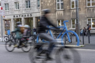 Bicycle parking spaces, with so-called leaning bars and a large blue bicycle silhouette, to make
