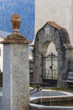 Village fountain in front of the entrance to the Firedhof, Tor, Guarda Engadin, Graubünden,